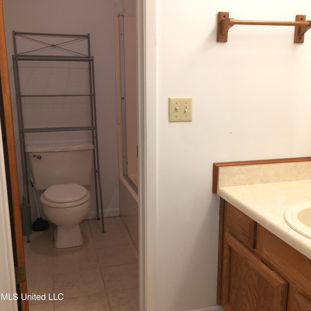 bathroom with tile patterned flooring, vanity, and toilet