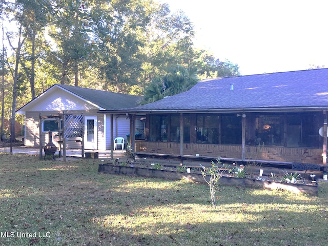 back of house with a lawn