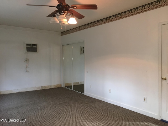 carpeted empty room with a wall mounted AC and ceiling fan