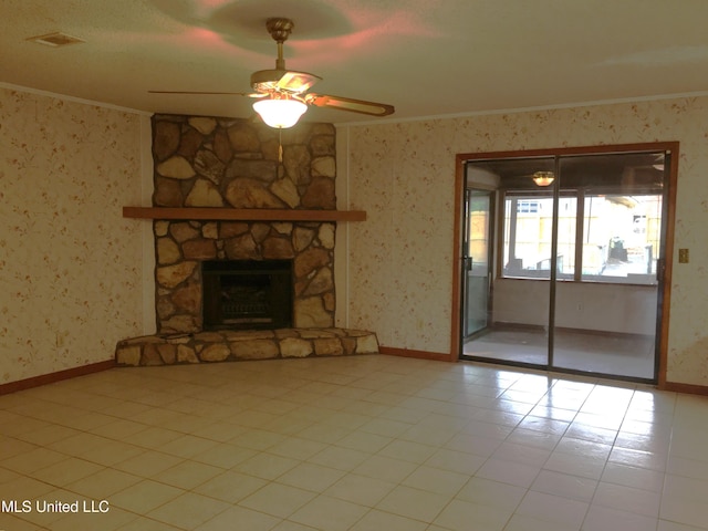 unfurnished living room with ceiling fan, ornamental molding, and a fireplace