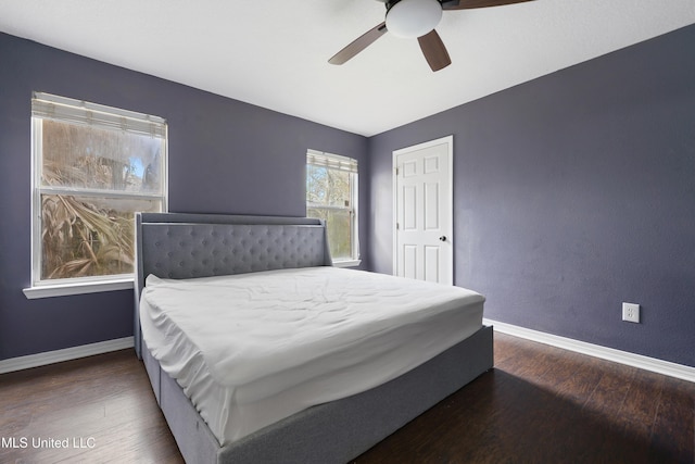 bedroom featuring a ceiling fan, wood finished floors, and baseboards