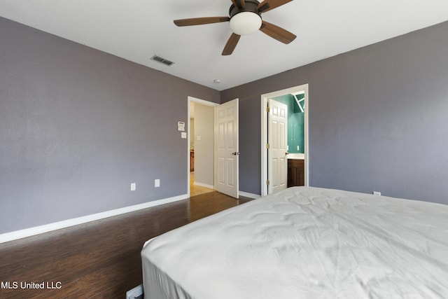 bedroom with visible vents, a ceiling fan, ensuite bathroom, wood finished floors, and baseboards