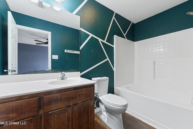 full bath with toilet, shower / bath combination, wood finished floors, vanity, and a ceiling fan