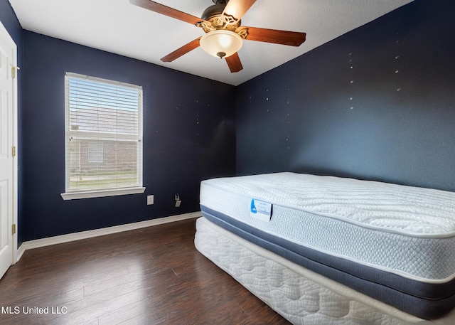 bedroom featuring a ceiling fan, baseboards, and wood finished floors