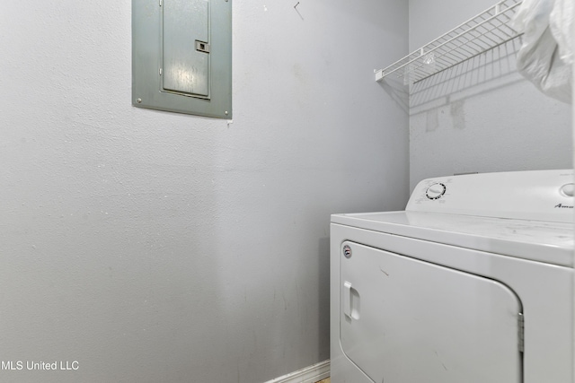 laundry area with electric panel, baseboards, washer / clothes dryer, and laundry area