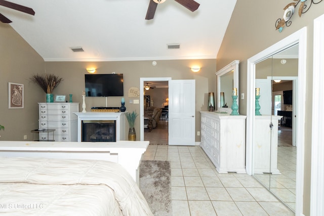 701 S Hill Ct, Biloxi, MS 39532 - bedroom featuring light tile patterned floors, a glass covered fireplace, crown molding, and a ceiling fan