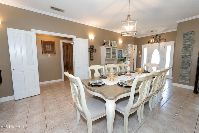 701 S Hill Ct, Biloxi, MS 39532 - dining space with a chandelier, light tile patterned flooring, and crown molding