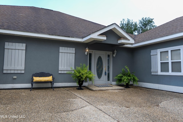 701 S Hill Ct, Biloxi, MS 39532 - doorway to property with roof with shingles and stucco siding