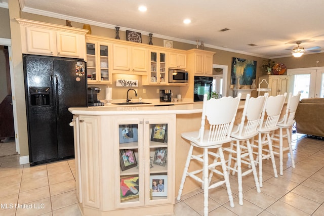 701 S Hill Ct, Biloxi, MS 39532 - kitchen with black appliances, a center island, ceiling fan, light tile patterned floors, and light countertops