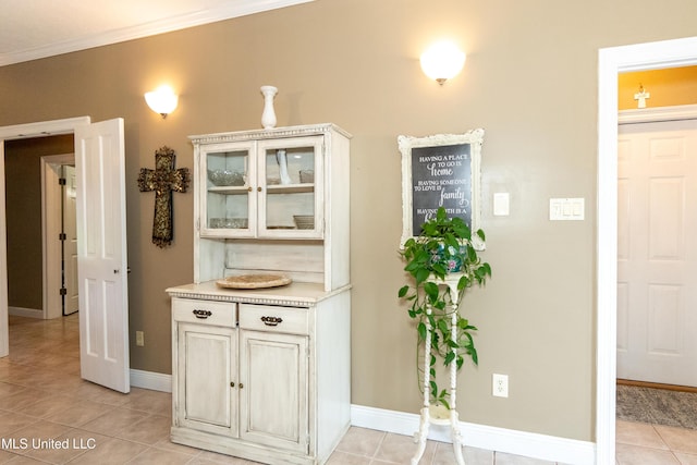 701 S Hill Ct, Biloxi, MS 39532 - bar area featuring light tile patterned flooring and ornamental molding