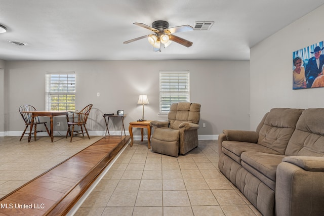 tiled living room featuring ceiling fan