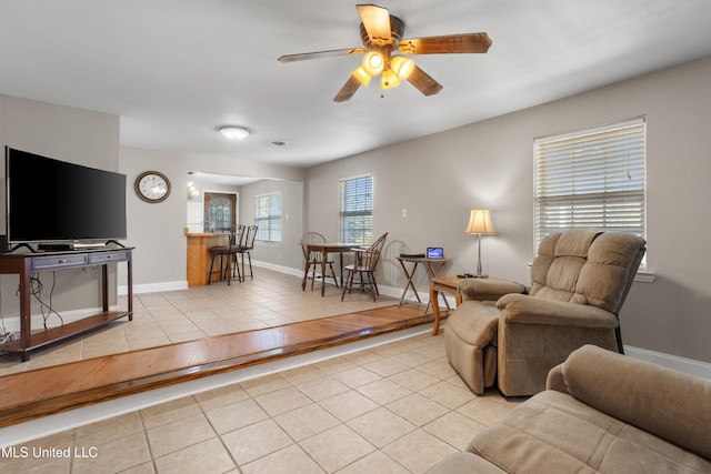 living room featuring ceiling fan and light tile patterned floors