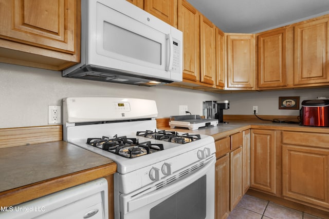 kitchen featuring white appliances and light tile patterned floors