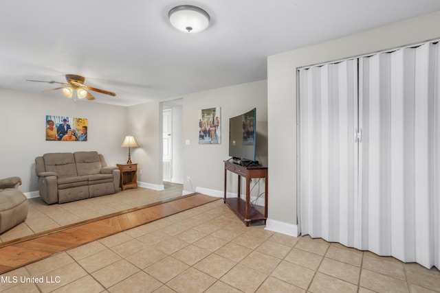 living room featuring ceiling fan and light hardwood / wood-style floors