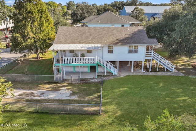 rear view of house featuring a lawn