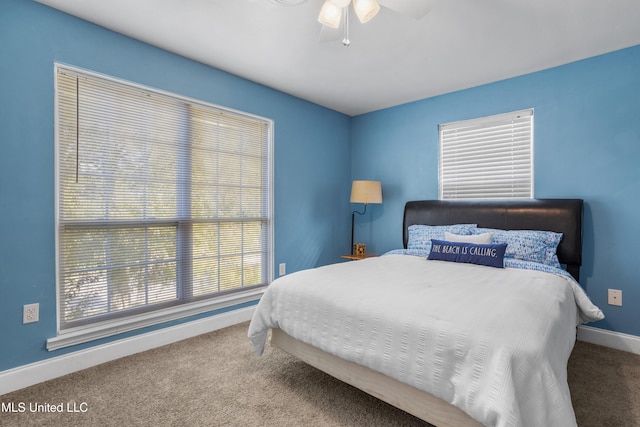 carpeted bedroom with multiple windows and ceiling fan