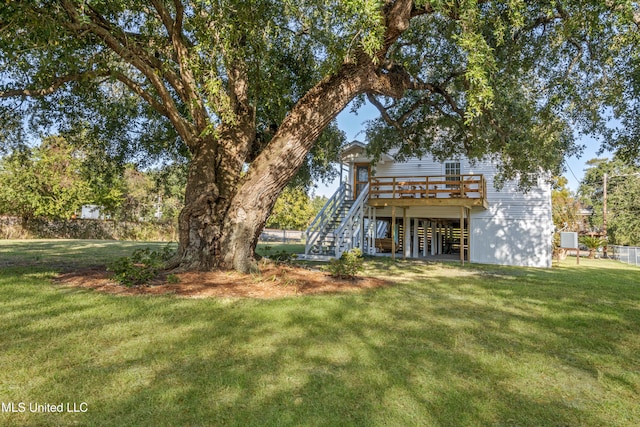 exterior space with a wooden deck and a lawn