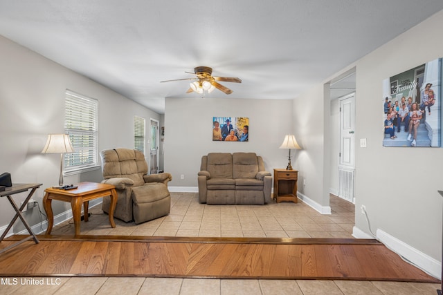 living room with light hardwood / wood-style floors and ceiling fan