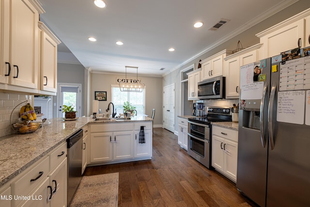 kitchen with decorative backsplash, dark hardwood / wood-style floors, sink, pendant lighting, and stainless steel appliances