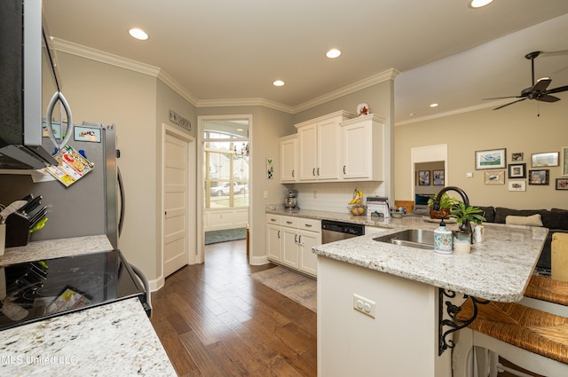 kitchen with white cabinetry, a kitchen bar, dark hardwood / wood-style floors, sink, and stainless steel appliances