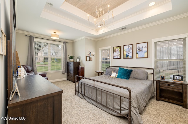 carpeted bedroom featuring crown molding, a notable chandelier, and a tray ceiling