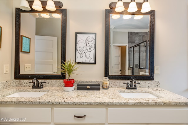 bathroom featuring vanity, ornamental molding, and a shower with door