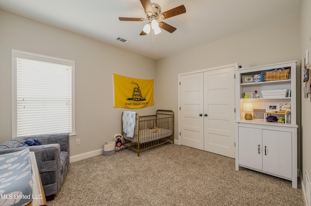 living area with light colored carpet and ceiling fan