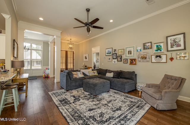 living room with ornate columns, crown molding, dark hardwood / wood-style flooring, and ceiling fan with notable chandelier