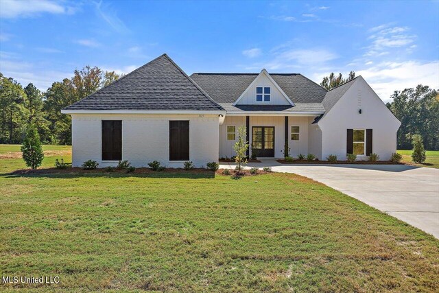 1025 Mullican Rd, Florence, MS 39073 - modern farmhouse with roof with shingles, french doors, a front yard, and concrete driveway
