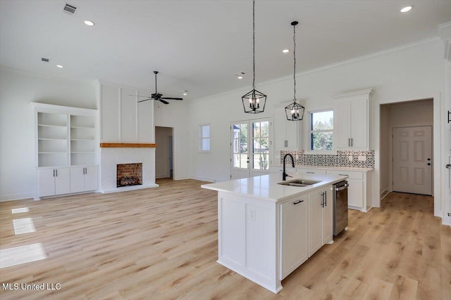 1025 Mullican Rd, Florence, MS 39073 - kitchen with ceiling fan, stainless steel dishwasher, a sink, open floor plan, and ornamental molding