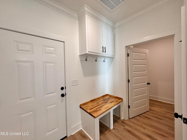 mudroom with crown molding and light hardwood / wood-style flooring