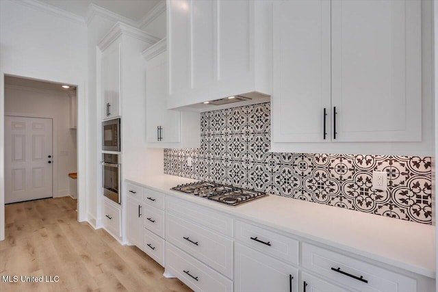 1025 Mullican Rd, Florence, MS 39073 - kitchen with crown molding, light countertops, stainless steel appliances, custom range hood, and backsplash