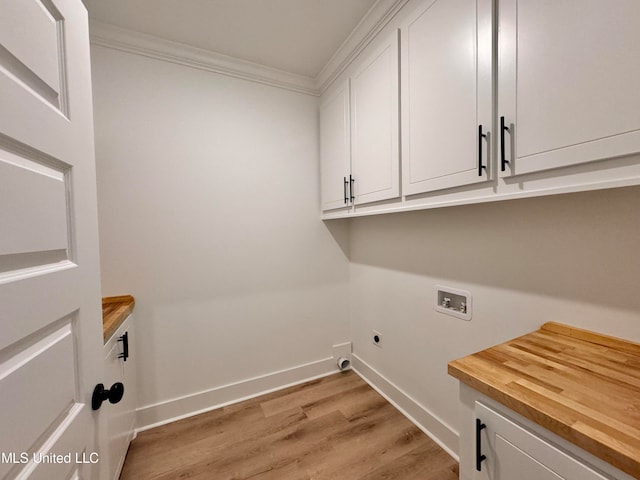 laundry area featuring cabinets, washer hookup, light hardwood / wood-style flooring, electric dryer hookup, and crown molding