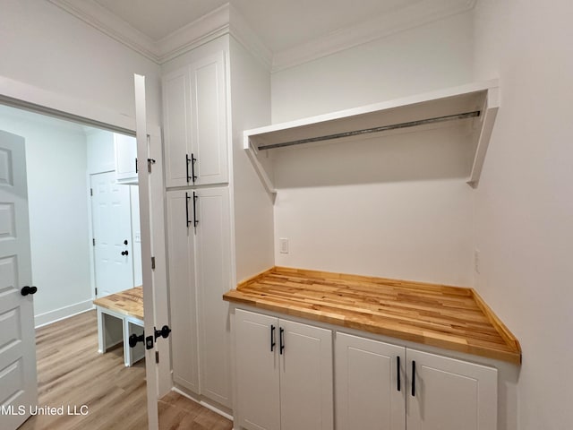 mudroom with light hardwood / wood-style floors and ornamental molding