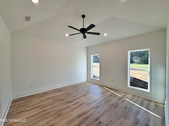 empty room featuring vaulted ceiling, light wood-type flooring, and ceiling fan