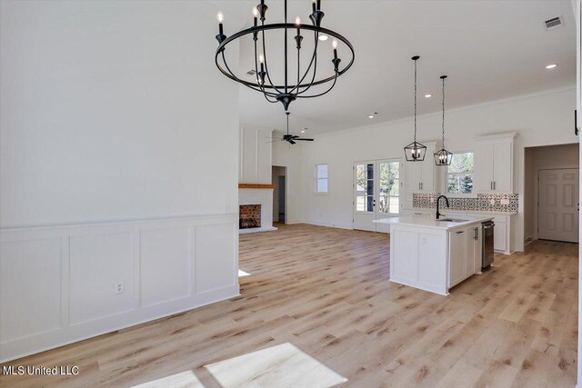 1025 Mullican Rd, Florence, MS 39073 - kitchen featuring an inviting chandelier, a sink, a decorative wall, an island with sink, and open floor plan