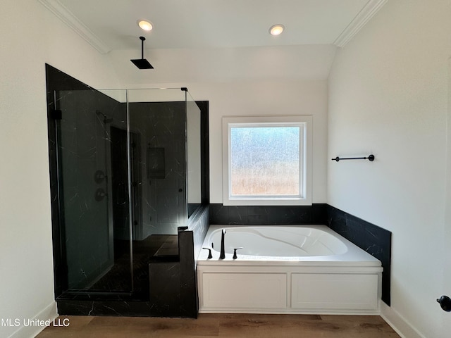 bathroom featuring ornamental molding, shower with separate bathtub, wood-type flooring, and vaulted ceiling