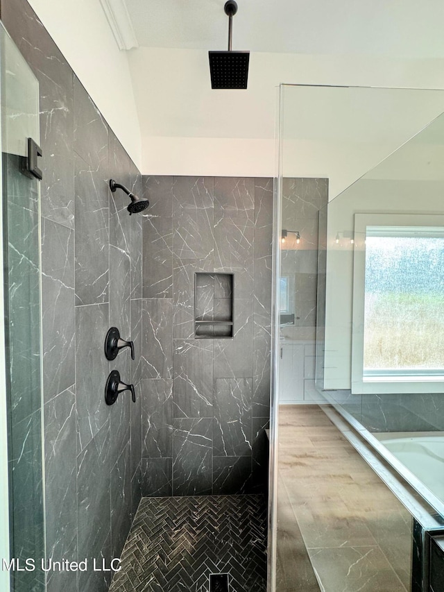 bathroom with tiled shower