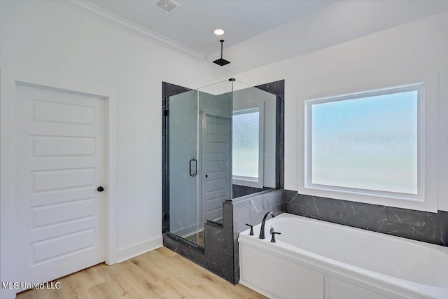 1025 Mullican Rd, Florence, MS 39073 - full bathroom with a garden tub, crown molding, visible vents, wood finished floors, and a stall shower