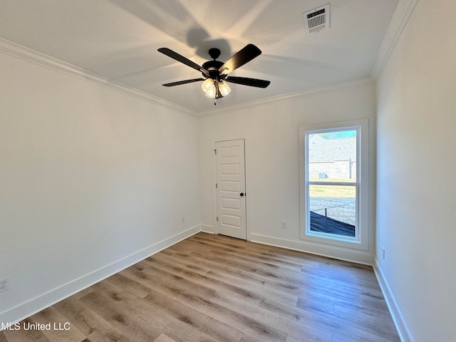 empty room featuring ceiling fan, crown molding, and light hardwood / wood-style floors