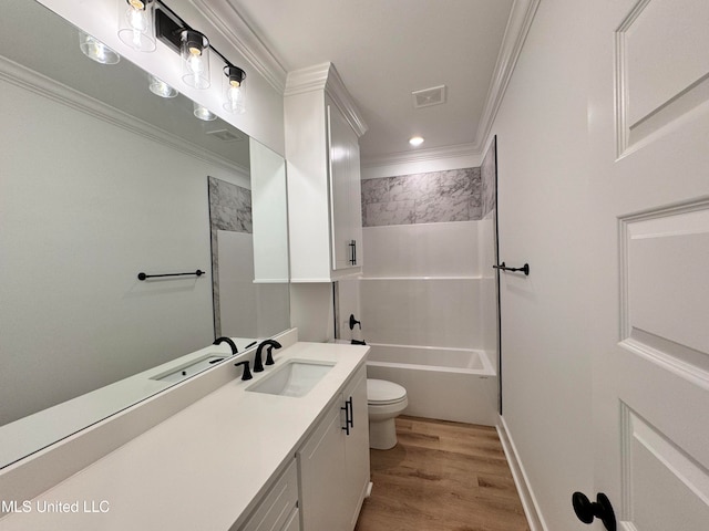 full bathroom featuring vanity, ornamental molding, hardwood / wood-style flooring, and toilet