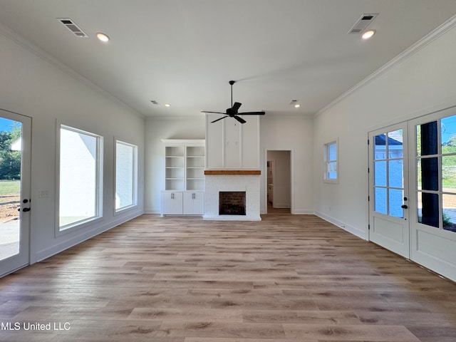 unfurnished living room featuring crown molding, ceiling fan, plenty of natural light, and light wood-type flooring