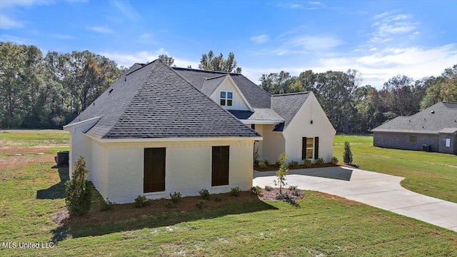 1025 Mullican Rd, Florence, MS 39073 - view of front facade featuring a shingled roof, concrete driveway, and a front lawn