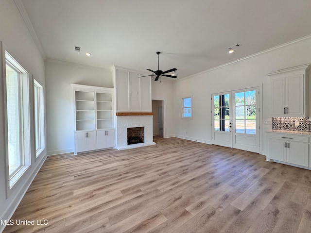 unfurnished living room with ornamental molding, light hardwood / wood-style floors, and ceiling fan