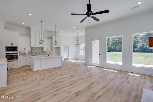 1025 Mullican Rd, Florence, MS 39073 - kitchen featuring decorative backsplash, visible vents, built in microwave, open floor plan, and oven