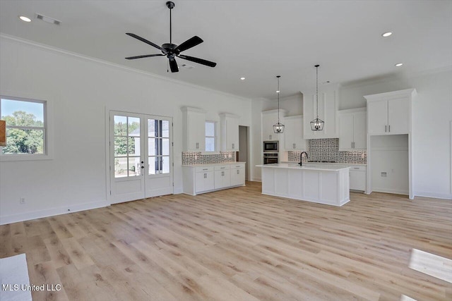 1025 Mullican Rd, Florence, MS 39073 - kitchen with crown molding, open floor plan, decorative backsplash, and black appliances