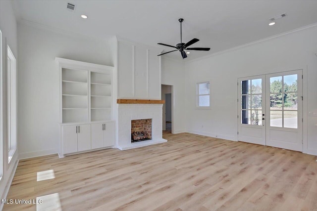 1025 Mullican Rd, Florence, MS 39073 - unfurnished living room with french doors, visible vents, crown molding, a brick fireplace, and light wood finished floors
