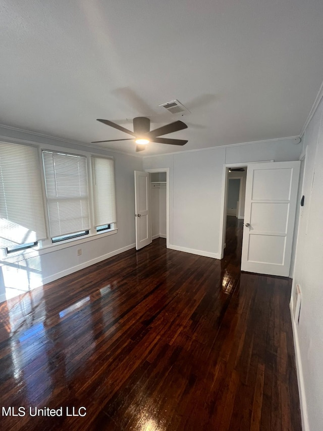 unfurnished bedroom featuring ornamental molding, a closet, and dark hardwood / wood-style floors