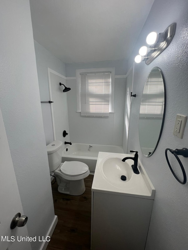 full bathroom with toilet, bathtub / shower combination, hardwood / wood-style floors, and vanity