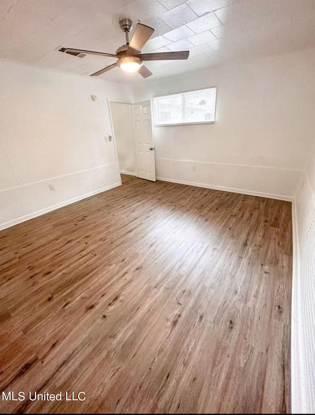 unfurnished room featuring hardwood / wood-style flooring and ceiling fan